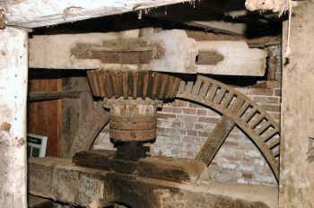 The upright shaft on its SKF bearing with the pit wheel behind stripped of its wooden teeth