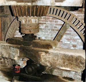 The upright shaft on its SKF bearing with the pit wheel behind stripped of its wooden teeth