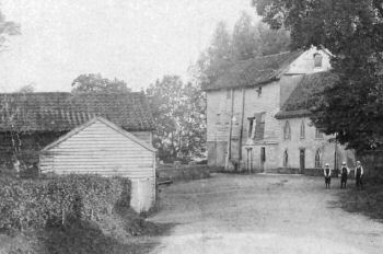 Three schoolgirls pose outside the mill c.1910