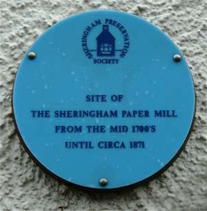 The plaque on the building said to occupy the site